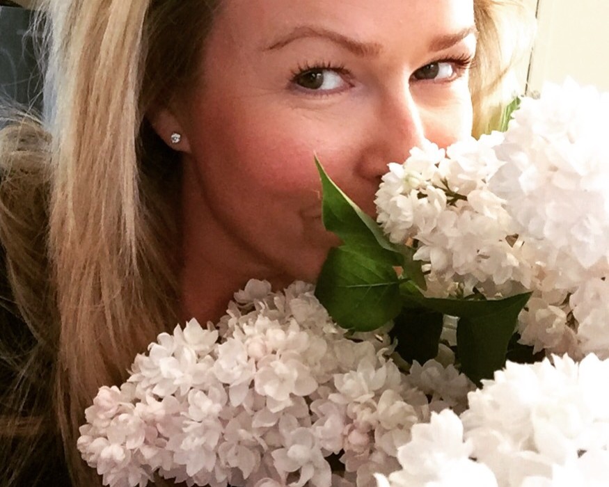 Tracy smelling lilac arrangement